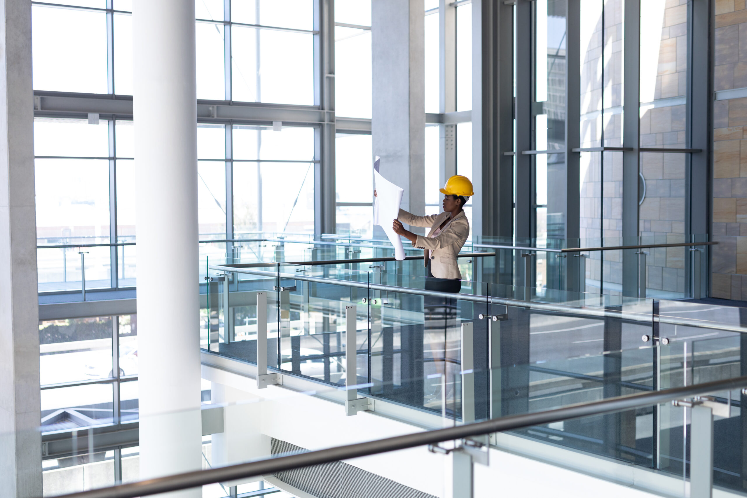 Woman looking at blueprint for commercial office renovation